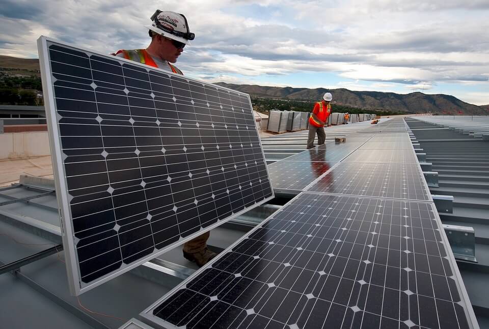 Two men working on a solar panel system.